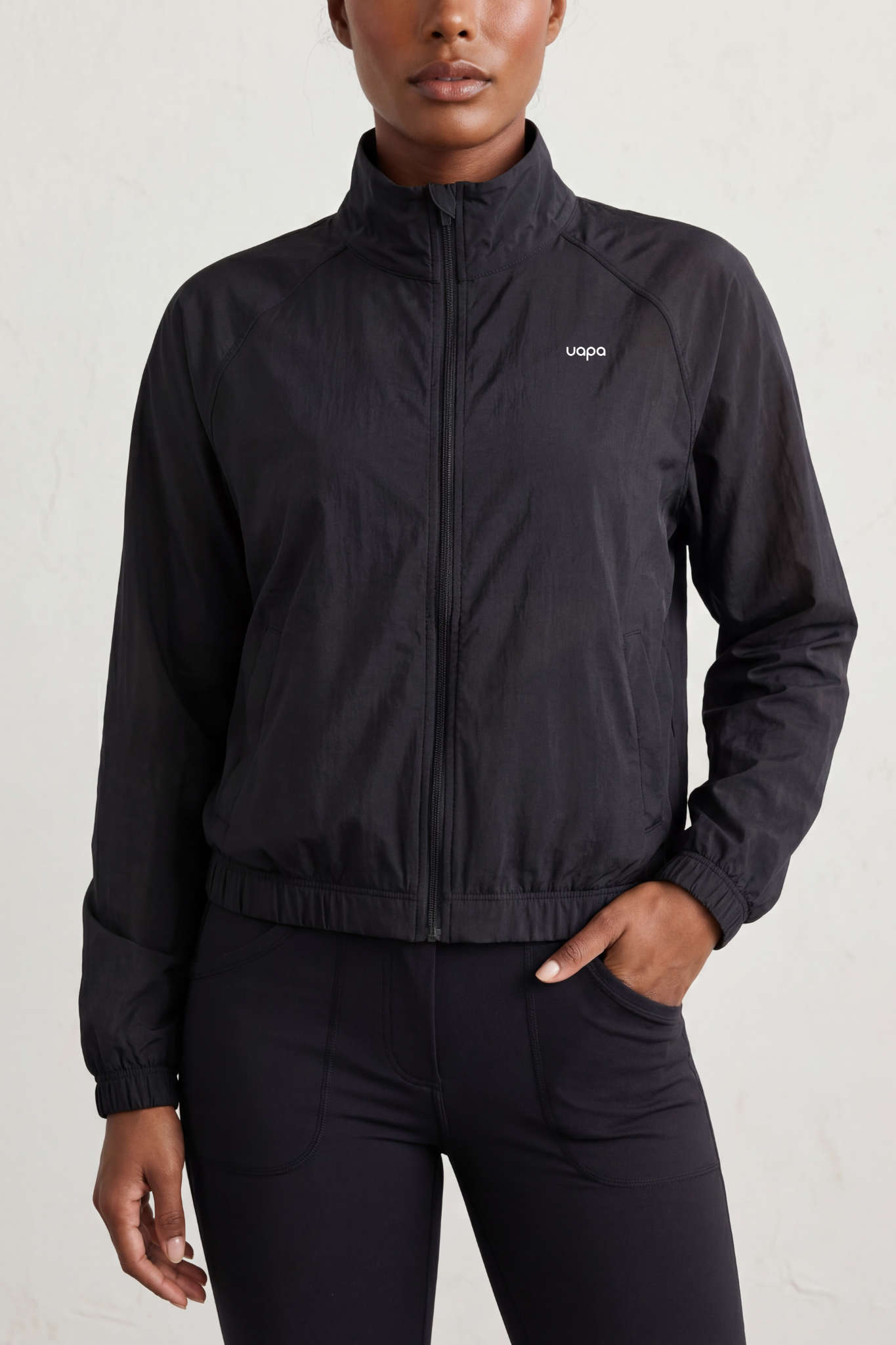 UAPA Studio Jacket in black — women's activewear jacket with UAPA logo