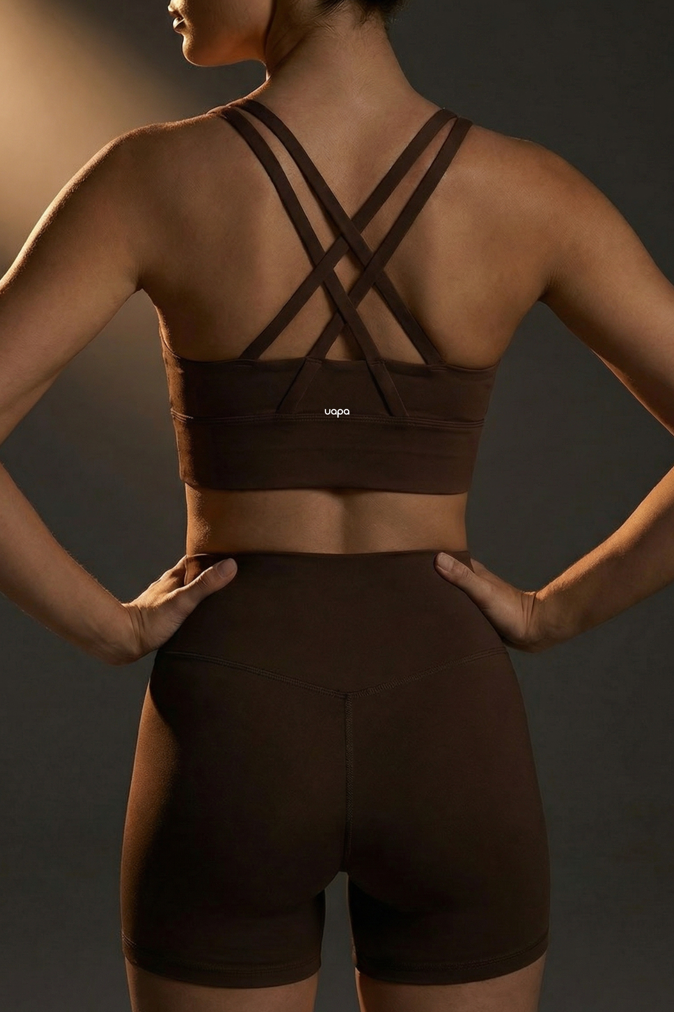 UAPA Core Bra in brown — back view showing the crossed straps and UAPA logo