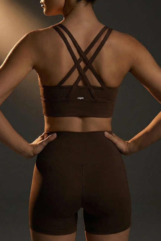 UAPA Core Bra in brown — back view showing the crossed straps and UAPA logo