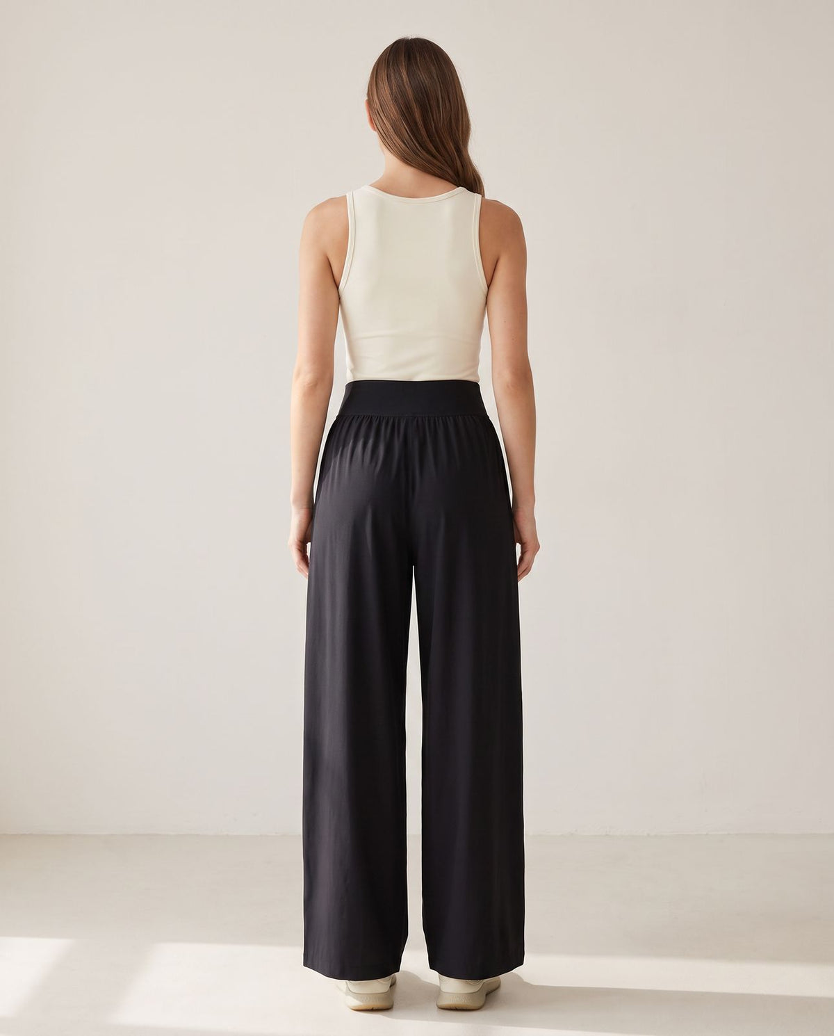 UAPA Flow Pant in black — women's activewear pants, back view